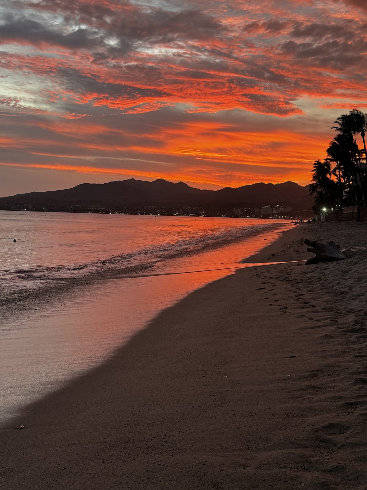 Sunset on the beach at Bucerías with the bay and mountains behind