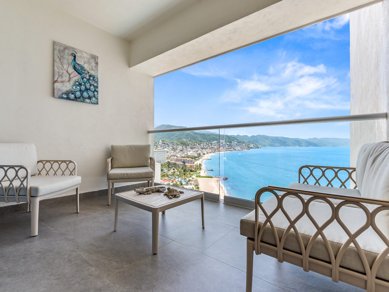 The terrace of Condo Cielo at Harbor 171, with lounge chairs looking out over Banderas Bay