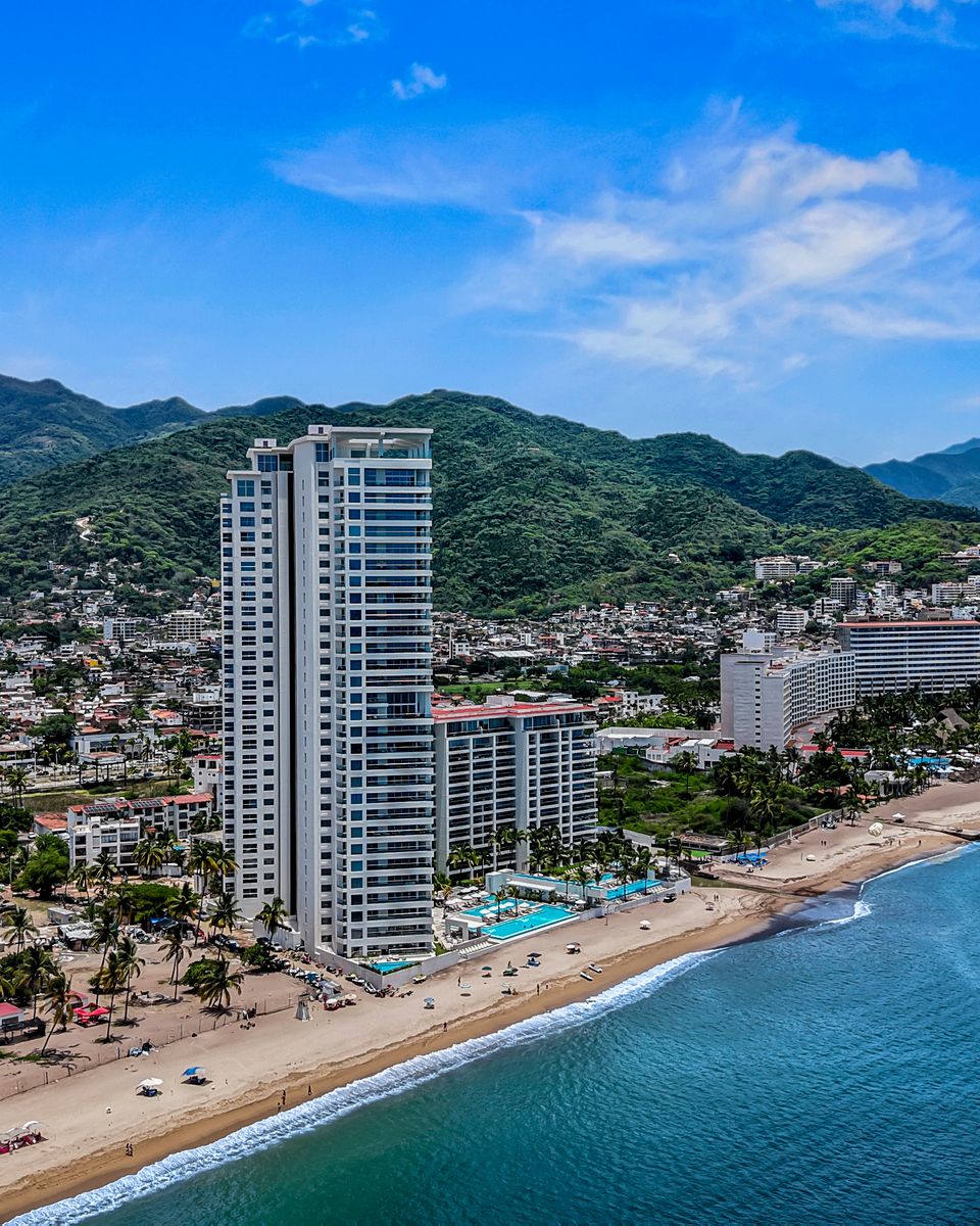 Harbor 171 on the Hotel Zone beach with the green hills behind