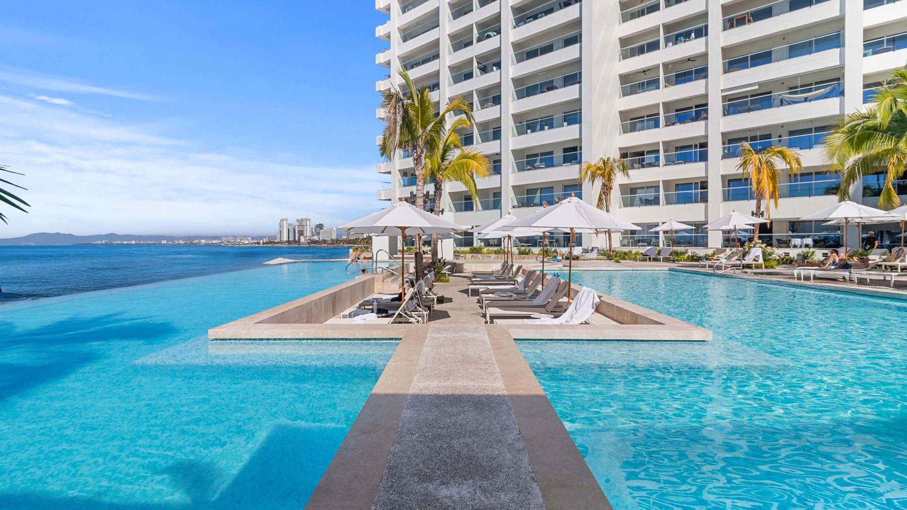 The beachfront infinity pools at Harbor 171 with the tower behind