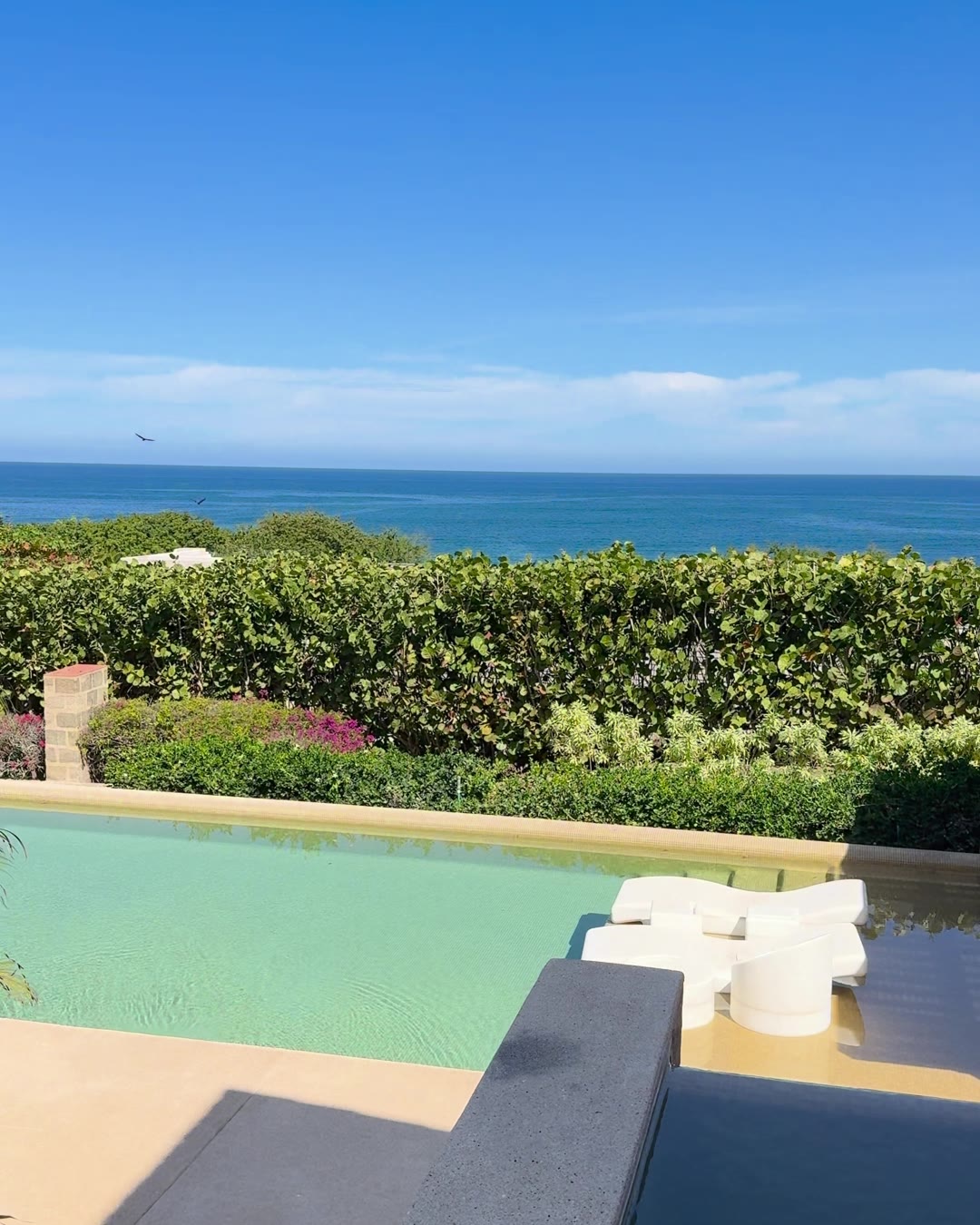 An infinity pool and lounge terrace looking straight out to the ocean