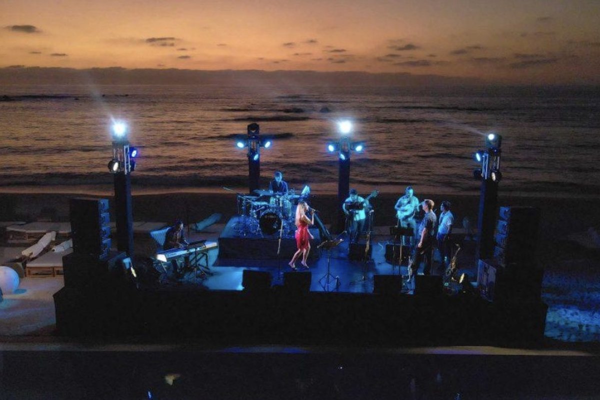A band on the beachfront stage at the Punta Mita Jazz Festival at sunset