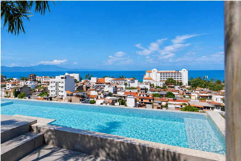 The rooftop infinity pool at Tr&oacute;pico 1371 looking out over the rooftops of 5 de Diciembre to Banderas Bay