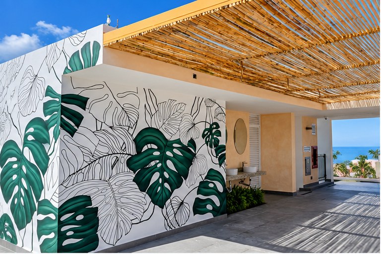 Trópico 1371 rooftop terrace with a hand-painted monstera mural and bamboo shade
