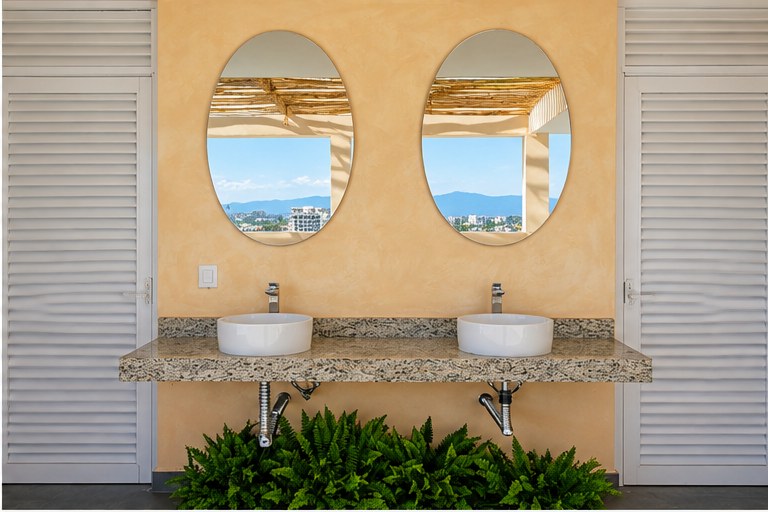 Twin vessel sinks and oval mirrors at Trópico 1371